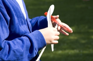 Girl winding the rubber band on a model helicopter