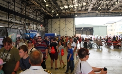 Crowd of people in aircraft hangar